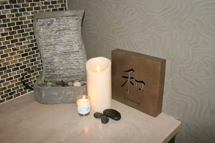 Warm stones and candles on the spa tray at Artistry Smile Center