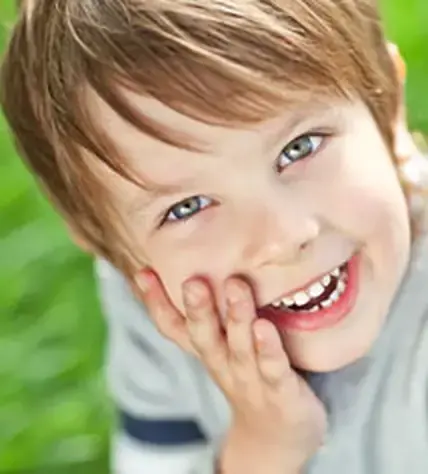 A child smiling at a children&rsquo;s dentistry visit